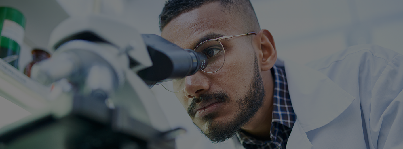 Man looking through microscope